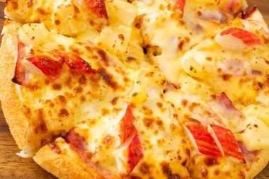 jambonlu ve yengeçli pizza veya Hawaii pizzası.