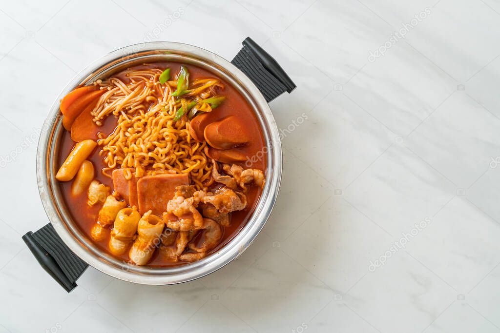 Budae Jjigae or Budaejjigae (Army stew or Army base stew). It is loaded with Kimchi, spam, sausages, ramen noodles and much more - popular Korean hot pot food style