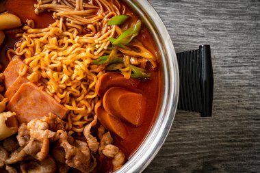 Budae Jjigae or Budaejjigae (Army stew or Army base stew). It is loaded with Kimchi, spam, sausages, ramen noodles and much more - popular Korean hot pot food style clipart