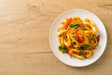 Kızarmış spagetti, tuzlanmış yumurta ve kalamar. Füzyon yemek stili.