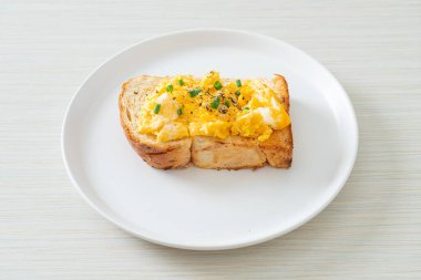 Ekmek tostu, çırpılmış yumurta ve beyaz tabak.