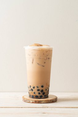 Taiwan milk tea with bubble and cheese burned on wood table clipart