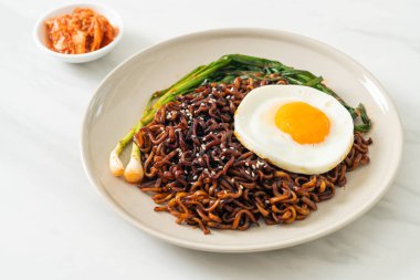 Ev yapımı kurutulmuş Kore baharatlı baharatlı siyah sos kızarmış yumurta ve kimchi ile hazır erişte.