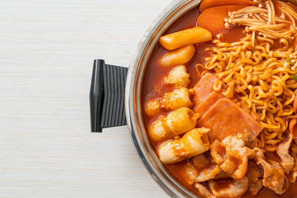 Budae Jjigae or Budaejjigae (Army stew or Army base stew). It is loaded with Kimchi, spam, sausages, ramen noodles and much more - popular Korean hot pot food style