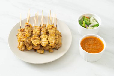 Fıstık soslu domuz eti turşusu salatalık dilimleri ve sirkeli soğan Asya yemeği tarzı.