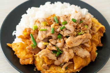 Pirinç üzerine sarımsak ve yumurta soslu kızarmış domuz eti. Asya usulü.