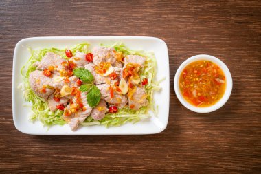 Baharatlı domuz salatası ya da limon sarımsaklı haşlanmış domuz eti ve acılı sos.