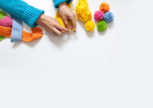 The woman knits a hook colored fabric. View from above. — Stock Photo, Image