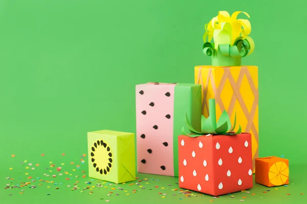 Gifts wrapped in colored paper. Gifts like fruit. Fruit boxes.