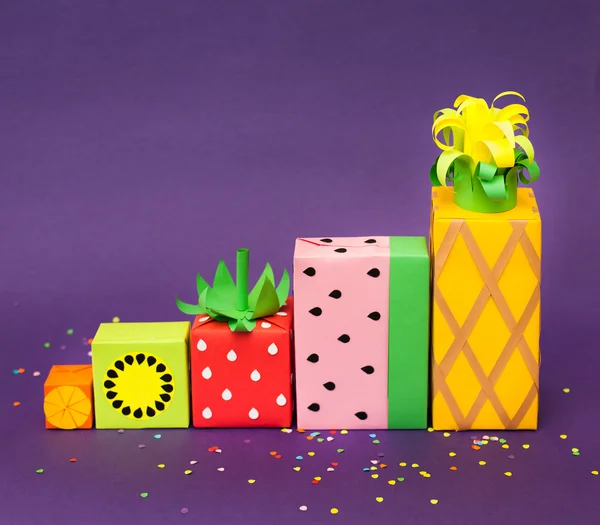 Gifts wrapped in colored paper. Gifts like fruit. Fruit boxes.