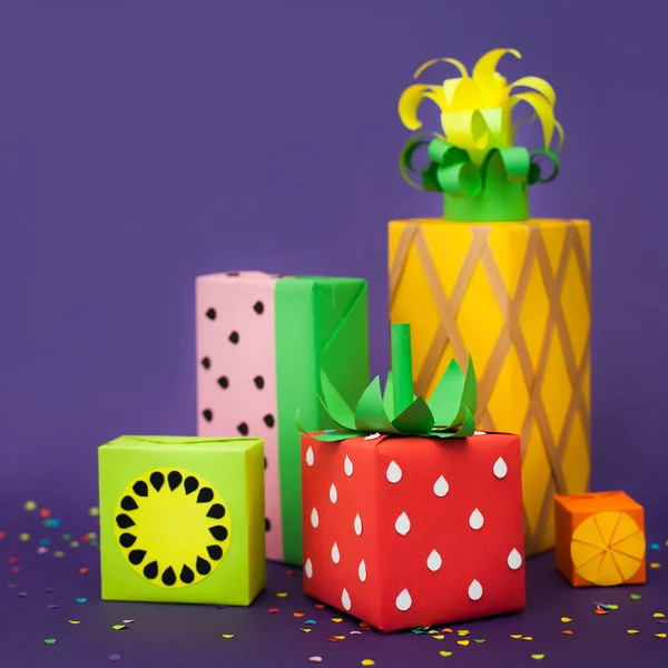 Gifts wrapped in colored paper. Gifts like fruit. Fruit boxes. Stock