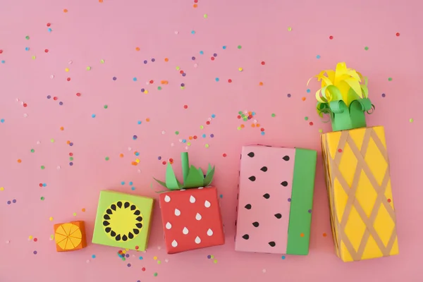 Gifts wrapped in colored paper. Gifts like fruit. Fruit boxes.