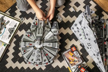 Khabarovsk, Rusya, Janyary 10, 2021. Bir çocuk, Star Wars filminden bir uzay gemisini oynuyor ve inceliyor. Yakınlarda İmparatorluk kruvazörü var.