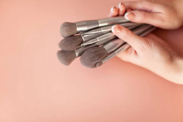 Female Hands Holding Group Makeup Brushes Powder Eyeshadow Isolated Coral — Stock Photo, Image