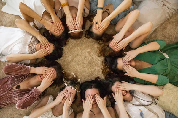Grupa zabawna moda kobiety przyjaciele pozowanie pokrycie oczy przez ręce leżące koło ciesząc się przyjaźń — Zdjęcie stockowe
