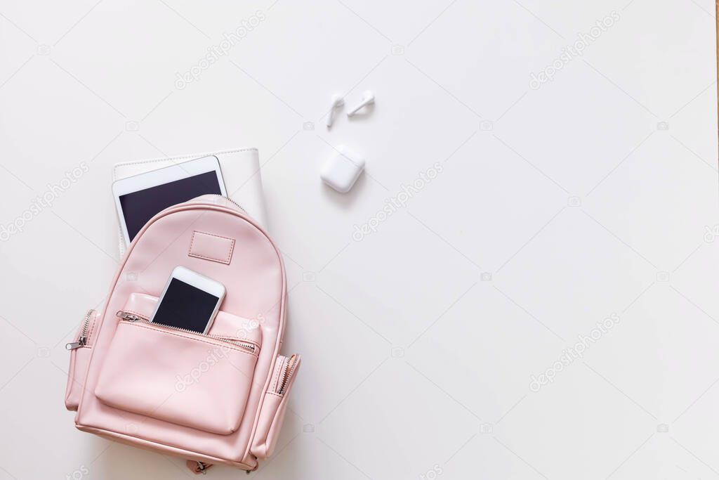 Student female backpack full of schooler supplies isolated with copy space. Back to school concept