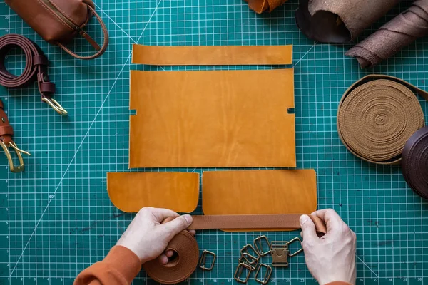 機器や材料で袋のプロセス切断スキーム。革工房で働く男性タンナー — ストック写真