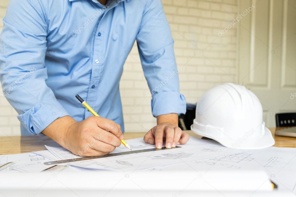 architect drawing architectural project on blueprint, engineerin