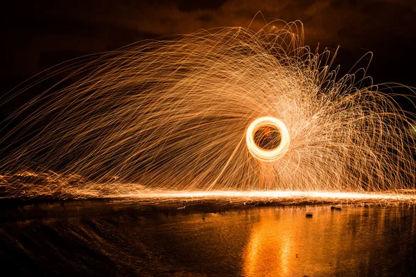 Spinning Steel Wool Sparks over Reflecting Pool of Water — Stock Photo, Image
