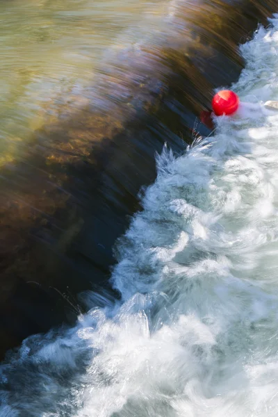 Leuchtend roter Ballon in fließendem Fluss gefangen — Stockfoto