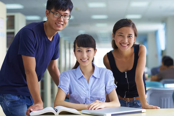 Jonge studenten studeren samen in de bibliotheek — Stockfoto