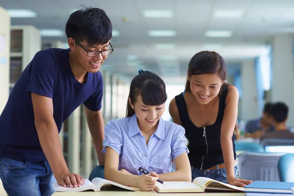 young college students study together in the library