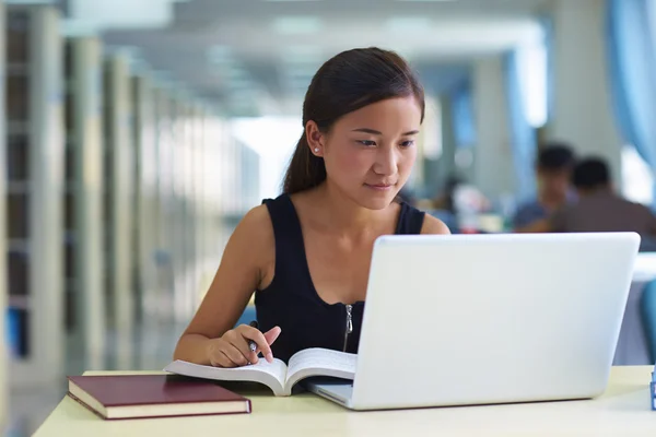 Una estudiante universitaria en la biblioteca —  Fotos de Stock