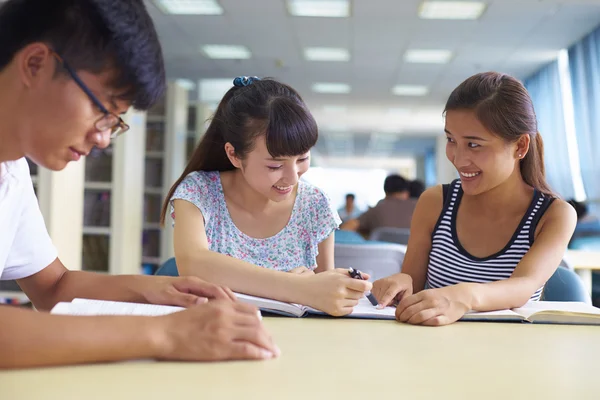 Young college students study together in the library — Stock Photo, Image