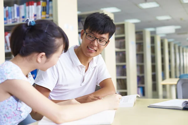 Young college students study together in the library — Stock Photo, Image