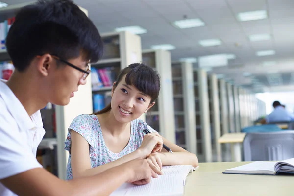 young college students study together in the library