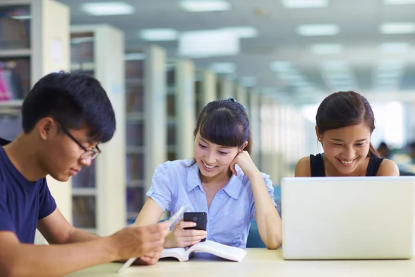 Young asian college student using laptop or tablet together in t — Stock Photo, Image