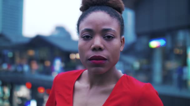 Schöne junge Afrikanerin im roten Kleid lächelt in die Kamera — Stockvideo