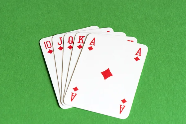 Speelkaart op groene tafel, Straight flush — Stockfoto