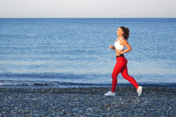 Positive Sportive Woman Summer Morning Jogging Beach Red Leggings Background — Stock Photo, Image