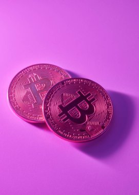 Pembe arkaplanda iki altın bitcoin izole edilmiş fotokopi alanı ile yakın plan.