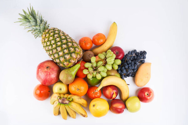 Mix of fresh juicy colorful exotic tropical fruits on white background top view