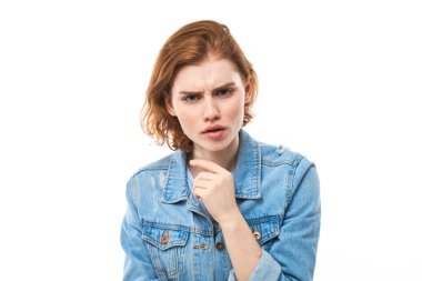 Şaşkınlık içindeki kızıl saçlı kız omuz silkiyor, sorgulayıcı bir jest yapıyor, cahil ve şaşkın bir görünüşü var, beyaz izole bir geçmişi olan bir kadın. Ne fark eder ki??