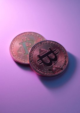 Pembe arkaplanda iki altın bitcoin izole edilmiş fotokopi alanı ile yakın plan.