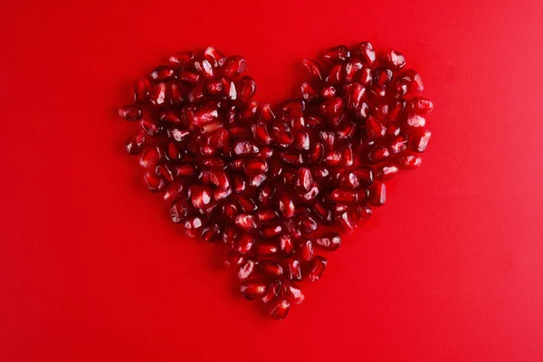 Semillas Granada Rubí Jugosas Forma Corazón Aisladas Sobre Fondo Rojo — Foto de Stock