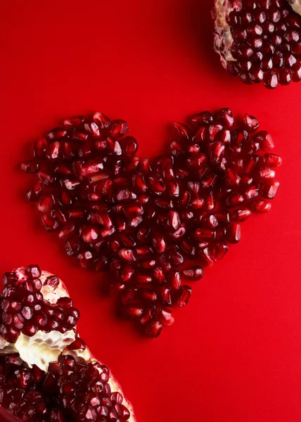 Heart Shaped Juicy Ruby Pomegranate Seeds Isolated Red Background Love — Stock Photo, Image