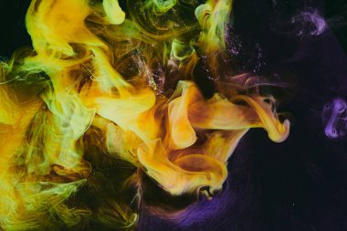 Abstract colorful smoke background. Moving flow of purple yellow paints, dark fluid art