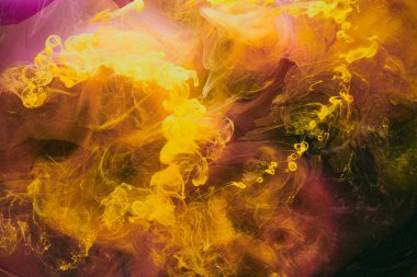Abstract colorful smoke background. Moving flow of purple yellow paints, dark fluid art