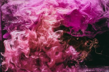 Abstract colorful smoke, dark background. Moving flow of pink paints, fluid art
