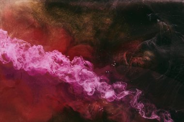 Abstract colorful smoke, dark background. Moving flow of pink paints, fluid art