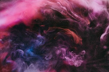 Abstract colorful smoke, dark background. Moving flow of pink paints, fluid art