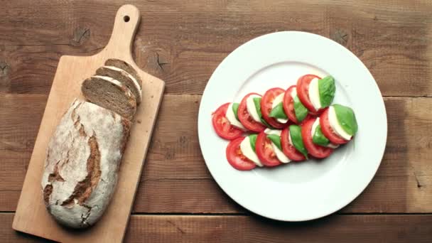 Caprese salad on white plate — Stock Video