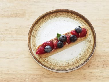Homemade strawberry and blueberry cheesecake for dessert on plate