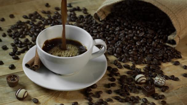 Black Coffee Poured into Coffee Cup on Wood Table — Stock Video