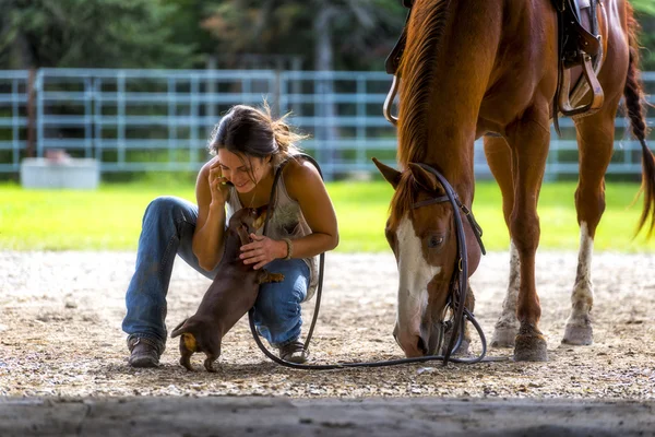 Farm girl on phone with horse and dog — Stock Photo, Image