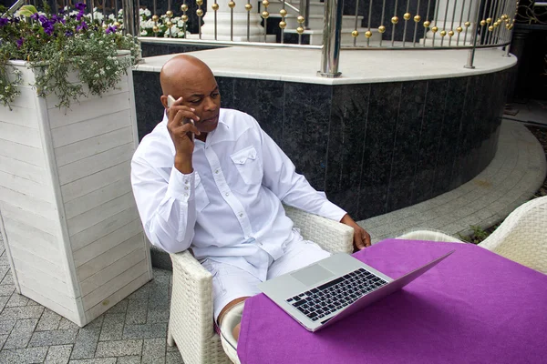 black man working with the lap top